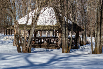 Russia. Kostroma health resort Lednevo. Spring. Wooden gazebo on a background of snow.