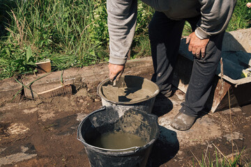 Kneading cement for pouring garden path, garden construction work