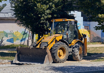 Fototapeta na wymiar Black and yellow tractor. Construction work concept. Machine for heavy earthworks. 