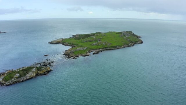 Dalkey Island, Dublin, Ireland, September 2021. Drone pushes along the length of the island passing the Fort, Martello Tower and St. Begnet's Church.