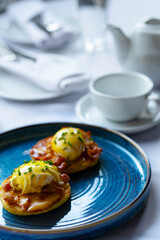 breakfast eggs on bread bacon teapot cup on the table