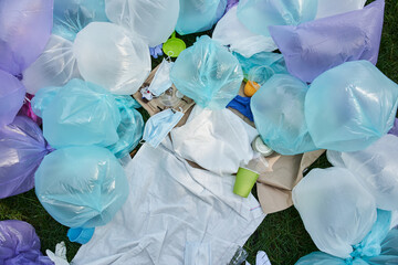 Cluttered and messy ground with piece of plastic bags, used protective masks and bottles
