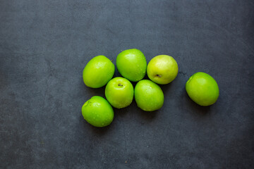 Fresh green jujube fruit isolated on dark background