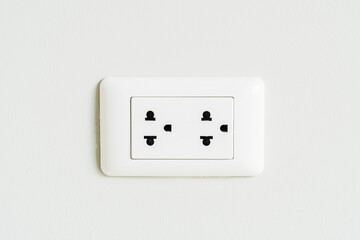 Electrical sockets In white cement wall of house. copy space for text.