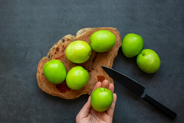 Fresh green jujube fruit isolated on dark background