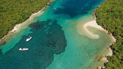 Fototapeta na wymiar Aerial drone photo of limestone tropical exotic island bay with crystal clear turquoise sea visited by yachts and sail boats in popular paradise destination