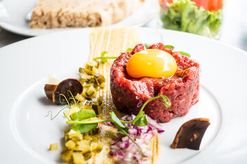 Tasty Steak tartare (Raw beef) - classic steak tartare on white plate