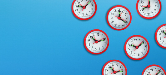 Alarm clocks with copy space on blue background