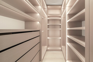 Wooden shelves with LED lighting inside closet cabinet, The vertical and horizontal strip LED light In wardrobe shelves. Modern minimalistic wardrobe interior