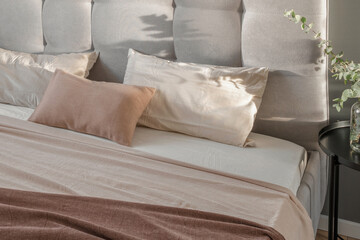 Fototapeta na wymiar Linen pillow cushions in minimal bedroom interior. Beige, white and cream pillows