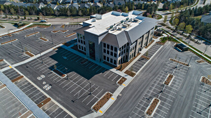 Deserted office building with an empty parking lot next to a residential neighborhood