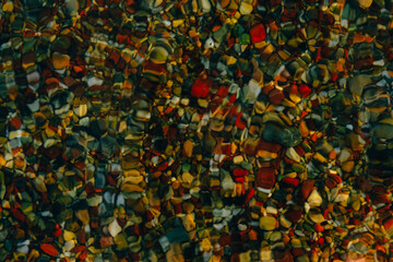 Fototapeta na wymiar Colorful sea pebbles under water. Beach stones.