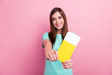 Photo of charming sweet young woman dressed turquoise t-shirt showing you passport smiling isolated pink color background