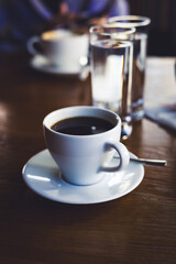 black coffee in a white cup on the table