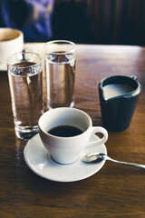 black coffee in a white cup on the table