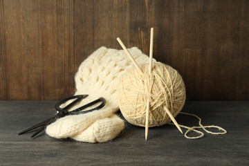 Concept of knitting with yarn ball on gray wooden table