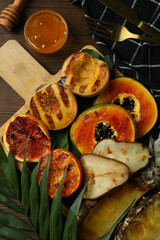 Concept of tasty food with grilled fruits on wooden background