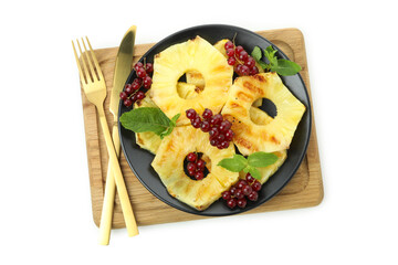 Board with grilled pineapple and cranberry isolated on white background