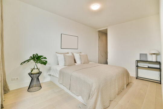Modern bedroom interior with bed under panel at home