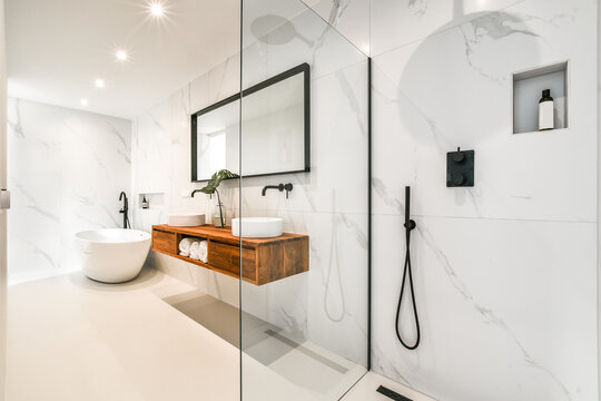 Modern bathroom interior with washbasins under mirror at home