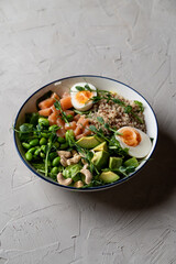 Quinoa bowl with beans and tofu, with a sliced hard boiled egg on the top, fresh and modern minimalist photo