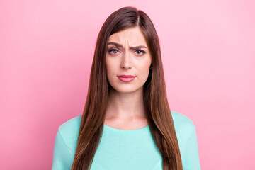 Photo of unsure pretty young lady wear teal t-shirt looking you isolated pink color background