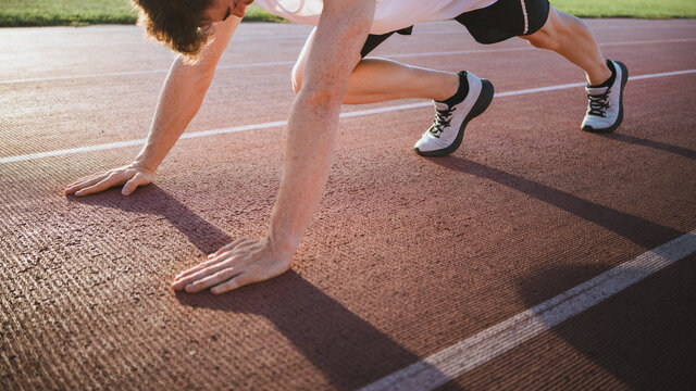 Crop runner preparing for workout on track