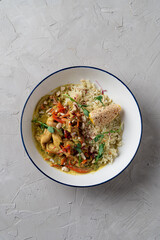 Indian chicken curry with basmati rice in white ceramic bowl, overhead shot for menu and commercials