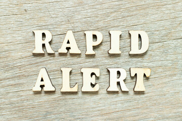 Alphabet letter in word rapid alert on wood background