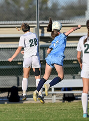 Obraz premium High school girls competing in a soccer match in south Texas