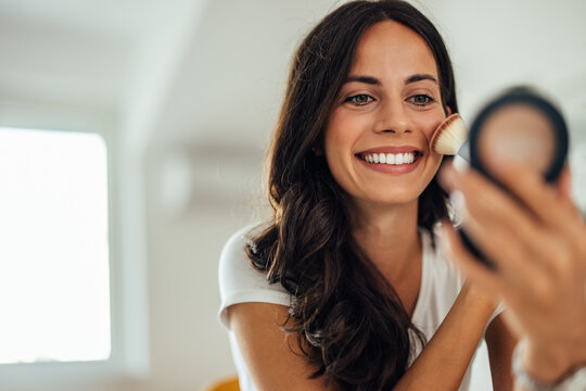Adult woman, trying out the new blush she ordered online.