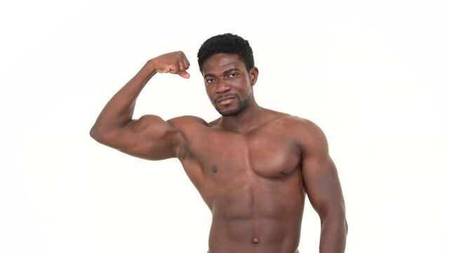 Portrait of an african man flexing one biceps. Isolated on a white background.