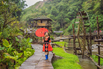 A female tourist dressed in the traditional dress of the inhabitants of the Vietnamese mountains,...