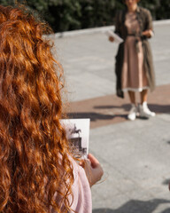 an elegant lady in the exhibition, wearing earphone to hear the voice guide