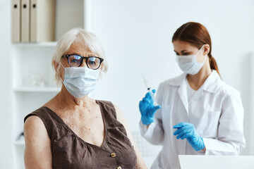 old woman wearing medical mask in the hospital for vaccinations covid-19 passport