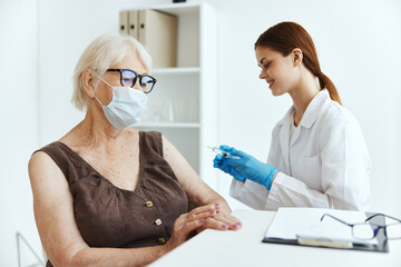 elderly woman wearing a medical mask covid passport vaccination