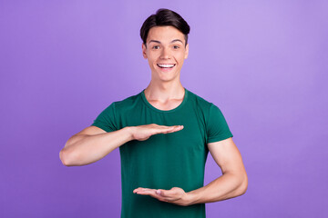 Photo of amazed excited happy positive man hands empty space measure isolated on violet color background