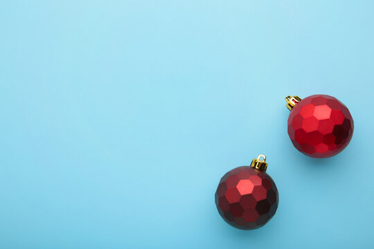 Red christmas decoration baubles on blue background with copy space