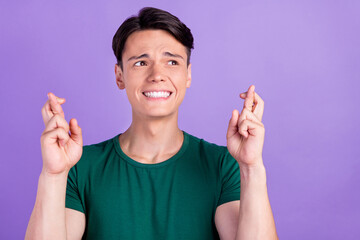 Photo of unhappy upset man crossed fingers look empty space nervous isolated on purple color...