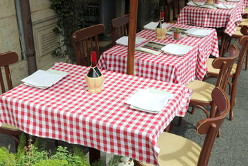 red and white checkered tablecloth of a restaurant with outdoor tables