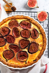 Fig Tart. Delicious tart with fresh figs and goat cheese on rustic wooden table. Top view