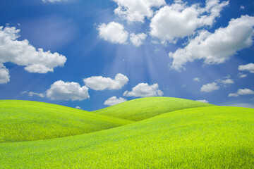 Landscape of green grass field on a hill with beautiful blue sky with clouds. ecology and natural background concept.