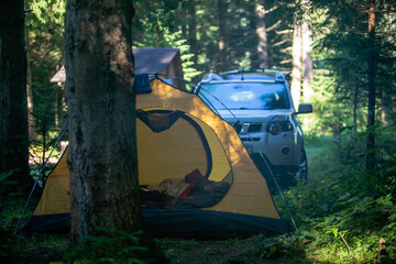 tent with suv car in forest