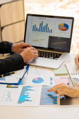 Vertical picture of business people analyzes and discusses and brainstorms data, charts, financial reports in the conceptual work consulting office. An accountant working on a desk using a calculator 