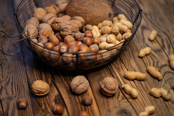 different kinds of nuts on a wooden background