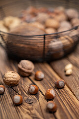 different kinds of nuts on a wooden background