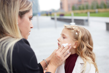 Young woman takes care of her crying daughter