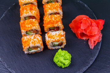 Sushi rolls Philadelphia on a black slate