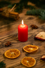 Traditional Czech Christmas on wood decoration with twig, candle, apple, orange, fruit