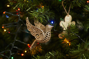 openwork bird in gold sequins. christmas decoration on the tree
